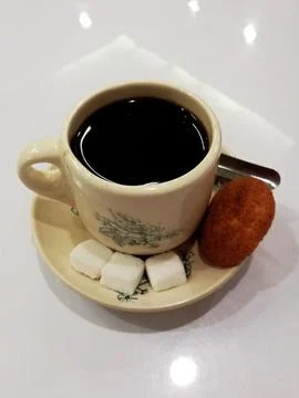 High angle view of a cup of coffee with some sugar cubes an a muffin. Food .. Stock Photos