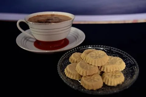 High angle view of a cup of coffee and a bunch of kue satu or kue koya Stock Photos