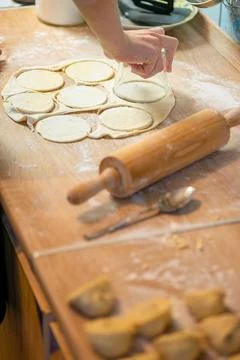 High angle view of cut dough circles with rolling pin Photos