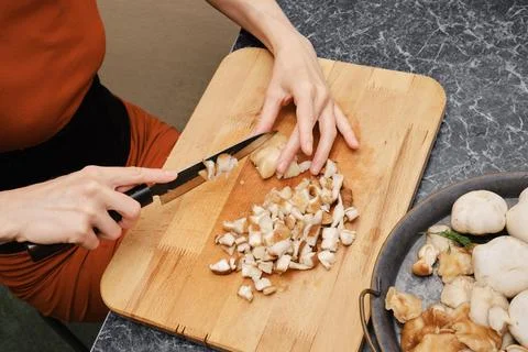 High angle view of cutting shiitake on wooden cutting board Stock Photos