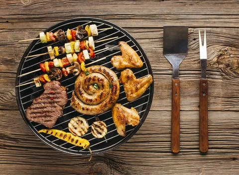 High angle view delicious grilled meat with vegetable coals barbecue. High Stock Photos