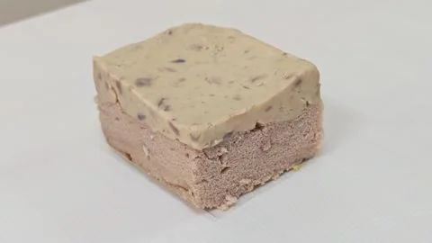 High angle view of a delicious taro chiffon cake slice with fudge topping. Vídeo Stock 348544906