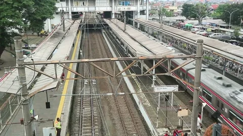 High angle view of Depok Baru commuter train station with a moving train. Stock Footage 339172611