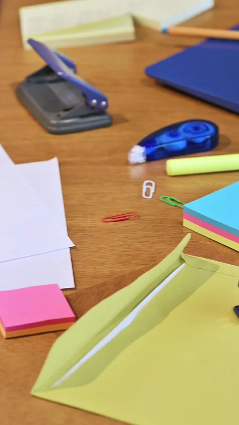 High angle view of desk with stapler, blue laptop, printed pie, bar charts .. 動画素材 335967072