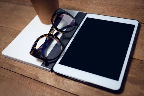 High angle view of digital tablet with diary and eyeglasses Stock Photos