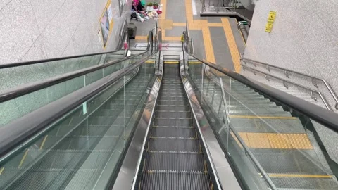 High Angle View Down Subway Escalator with Tactile Paving and Vendor Vidéo 342333745