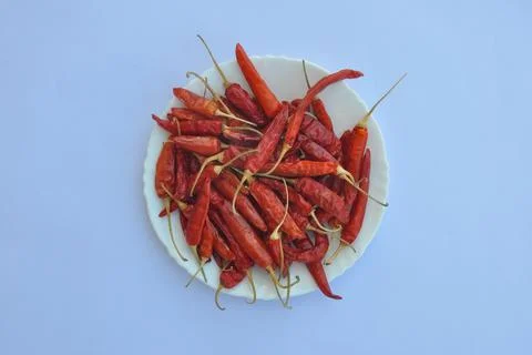 High angle view of dry red chilli peppers on the white plate  Stock Photos