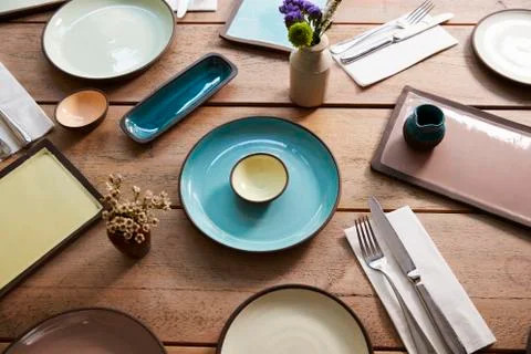 High angle view of earthenware and cutlery on a table Stock Photos
