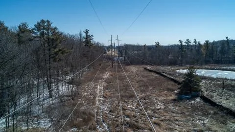 High Angle View of Electricity Power Transmission Lines Over Winter Forest Stock Photos