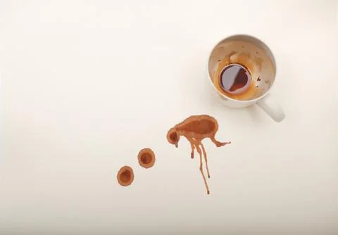 High angle  view of empty coffee mug with wet coffee drops on white paper Stock Photos