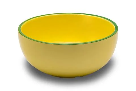 High angle view of empty single yellow ceramic bowl with green edge. Stock Photos