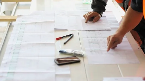 High angle view of engineers checking measures in hospital sketches. 스톡 동영상 99972801