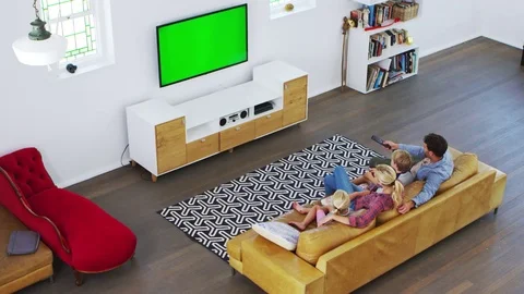 High Angle View Of Family Sitting On Sofa In Lounge Watching TV Stock Footage 78949191