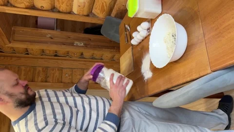 High angle view of father holding flour jar near table Stock-Footage 347363290