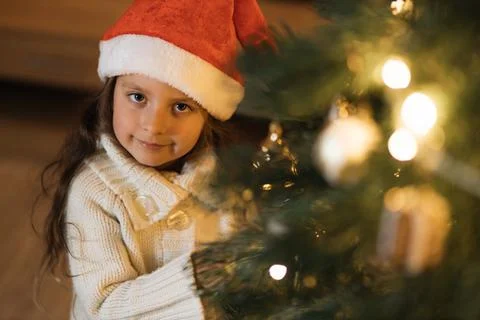High angle view of female child decorating Xmas tree in beautiful living room. Stock Photos