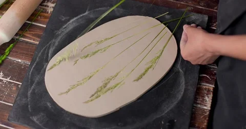 High angle view of female hands removing leaf out of clay plate. Close-up, slow Stock Footage 155618418