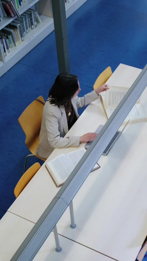 High Angle View of a Female Student Studying in a University Library Video stock 336042620