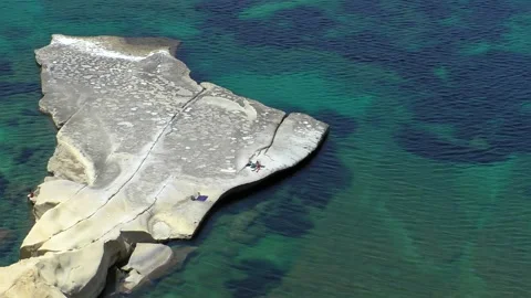 High angle view of few people on huge flat limestone rock 動画素材 148516302