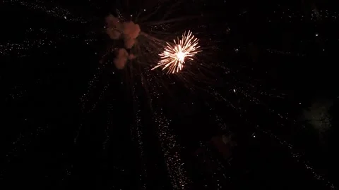 High-angle view of fireworks exploding in the darkness, symbolizing New Year Video stock 325949160
