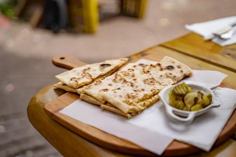 High angle view of flatbread with pickles served on table at sidewalk cafe Stock Photos