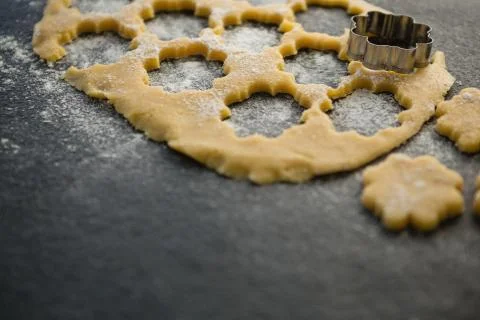 High angle view of flower shape pastry cutter on dough Fotos de archivo
