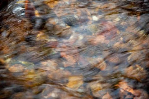 High angle view flowing stream over colorful stones nature background Foto stock