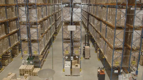 High angle view of forklift with boxes driving through industrial warehouse Stock Footage 154797606