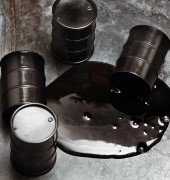 High angle view on four fuel barrels with spilled oil Stock Photos