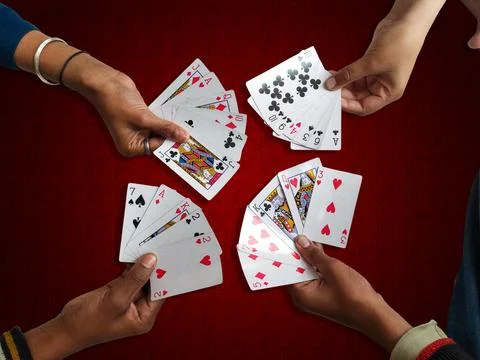 A high angle view of the four hand-held playing cards Stock Photos