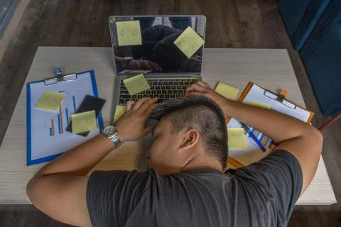 High angle view of freelancer man fall asleep on laptop Stock Photos