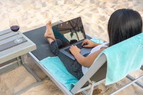 High angle view of freelancer using laptop on the beach Stock Photos