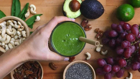 High angle view of fresh and healthy smoothie ingredients. Woman hand holding Stock Footage 259150898