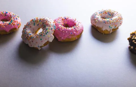 High angle view of fresh donuts with colorful sprinklers by copy space on Stock Photos