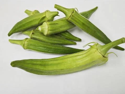 High Angle View of Fresh Green Okra Pods on White Background. Stock Photos