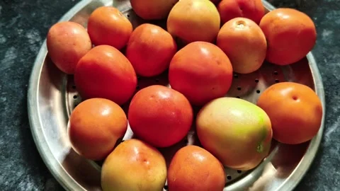 High angle view of fresh red and orange tomatoes kept on a stainless steel plate 스톡 동영상 328229780