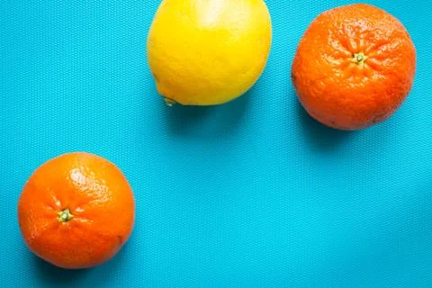 High angle view of fresh tangerines on a turquoise blue background in a studio Stock Photos