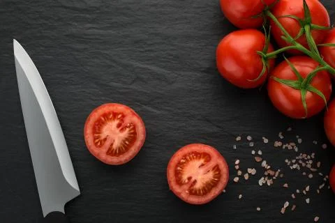 High angle view of freshly picked, juisy tomatoes on dark stone background Stock Photos