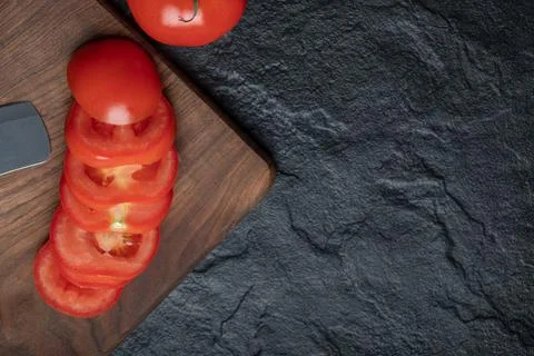 High angle view of freshly picked, juicy tomatoes on dark stone background Stock Photos