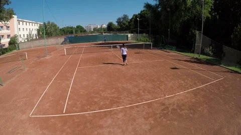 High angle view of friends play tennis at outdoors course arena Stock Footage 81149246
