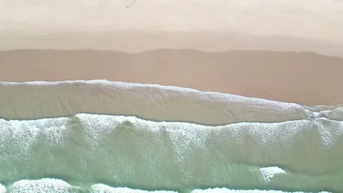High-Angle View of Gentle Waves Crashing on a Pristine Beach Stock Footage 310611746
