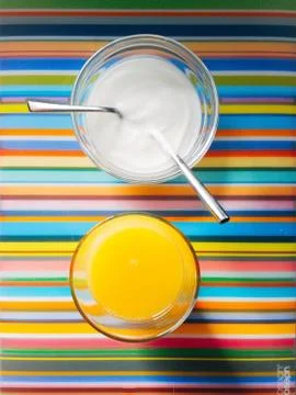 High Angle View Of Glas With Orange Juice &amp; Yogurt Served In Plate on Colorfu Stock Photos