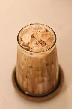 High-angle view of glass of an iced coffee with creamy milk. Cold brew coff.. Stock Photos