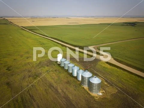 High angle view of Grain storage bins at Canadian prairies against sky Stock Photos