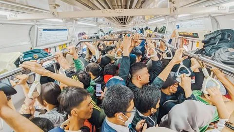High angle view. Group of adults standing close together inside the train Stock Photos