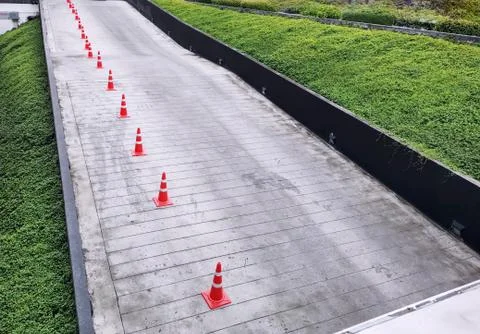 High Angle View of Group of Orange Traffic Cones Along the Road Foto stock