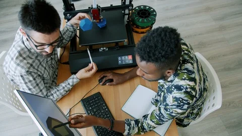 High angle view of guys making 3d model with printer using computer in office Stock Footage 119572099