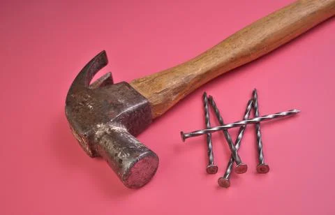 High Angle View of Hammer and Nails Isolated on a Pink Background Stock Photos