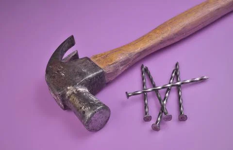 High Angle View of Hammer and Nails Isolated on a Lavender Purple Background Stock Photos