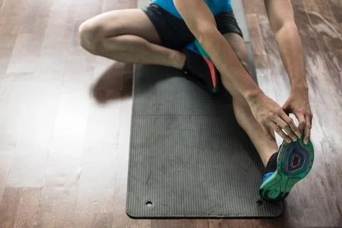 High-angle view of the hands of a man touching his toes as a str Stock Photos