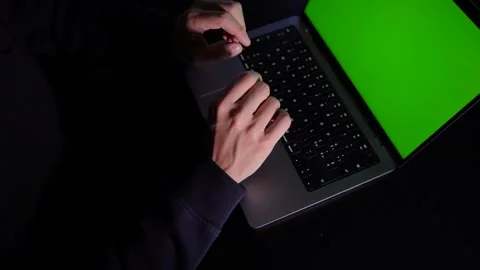 High Angle View of Hands Typing on Laptop with Green Screen Display Stock Footage 256468292
